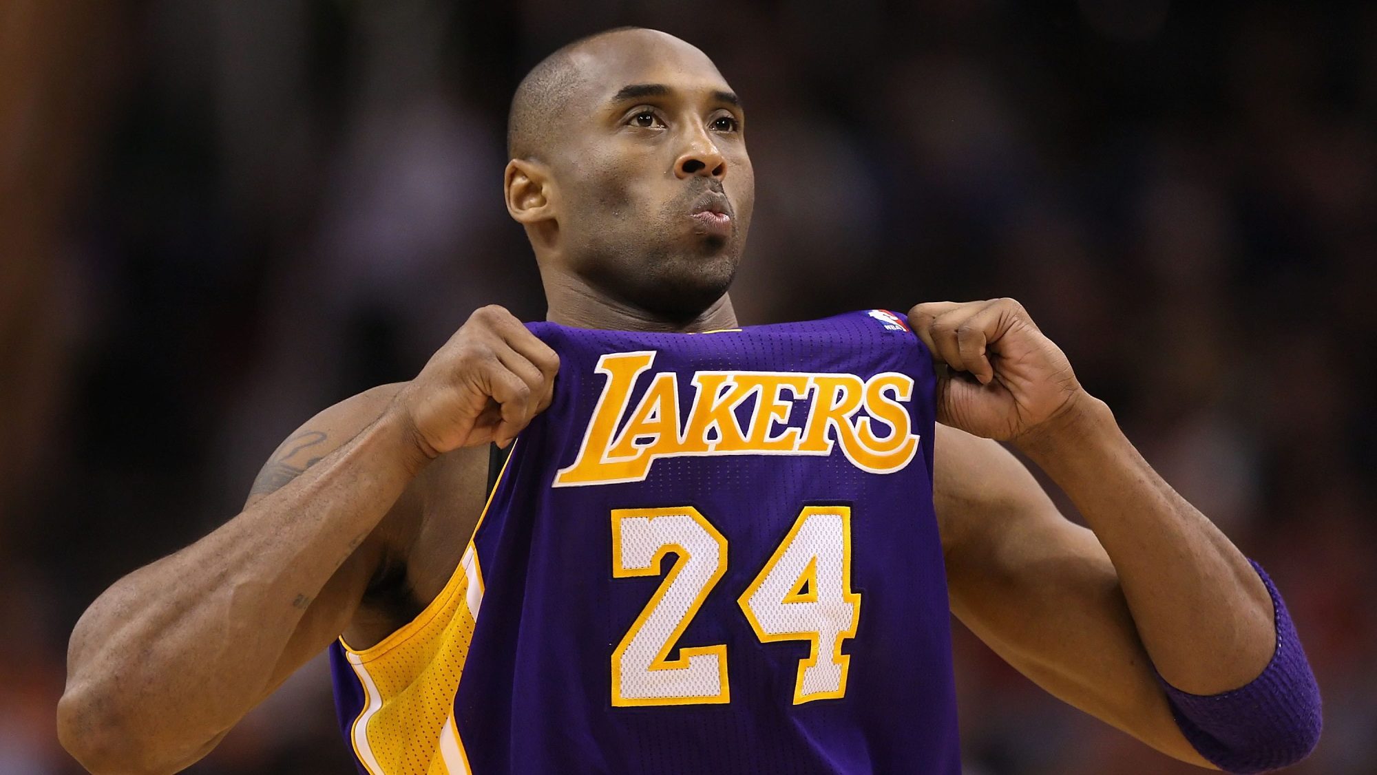 Kobe Bryant #24 of the Los Angeles Lakers adjusts his jersey during the NBA game against the Phoenix Suns at US Airways Center on February 19, 2012 in Phoenix, Arizona