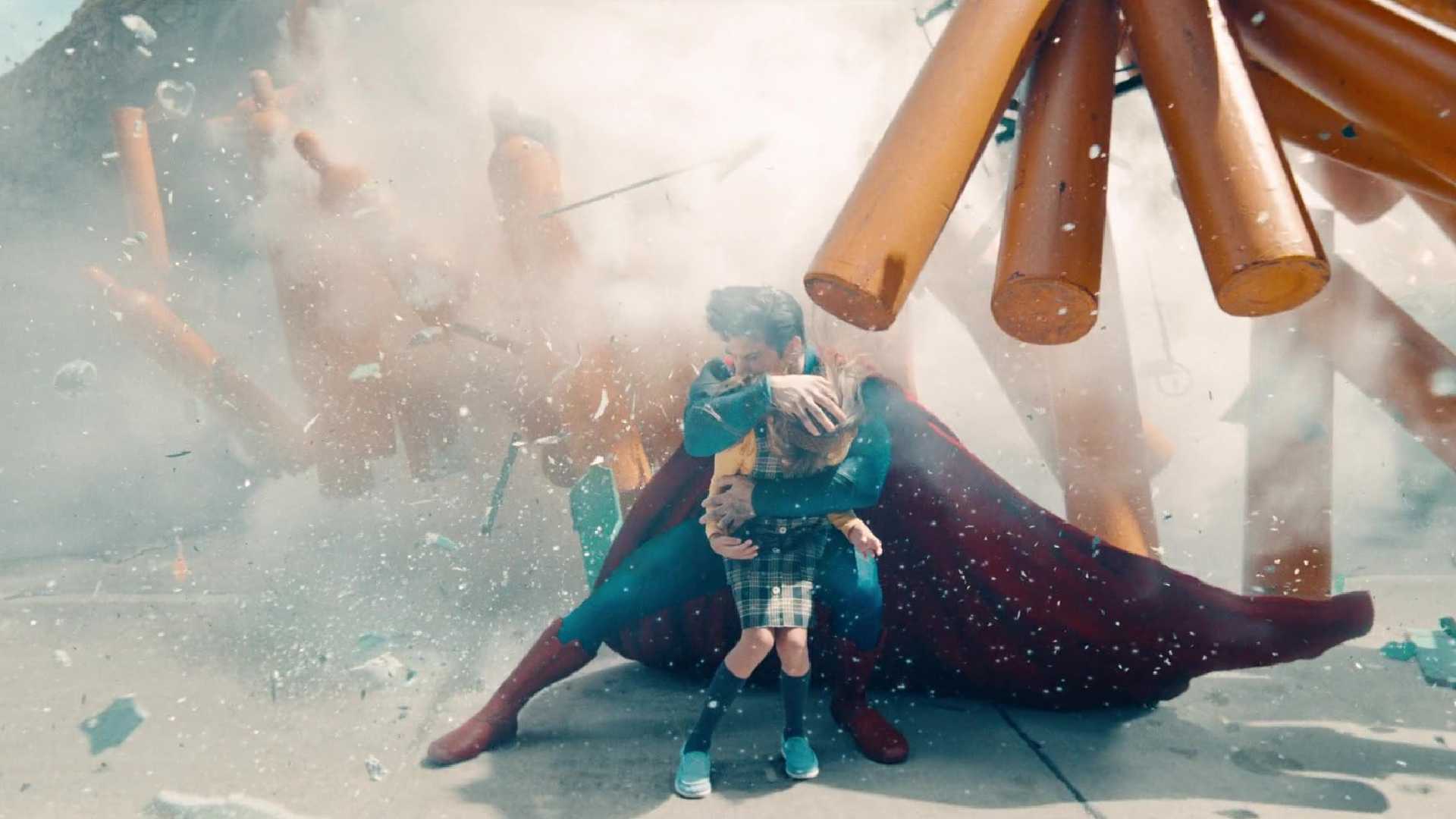 Superman protects a child from debris in Superman
