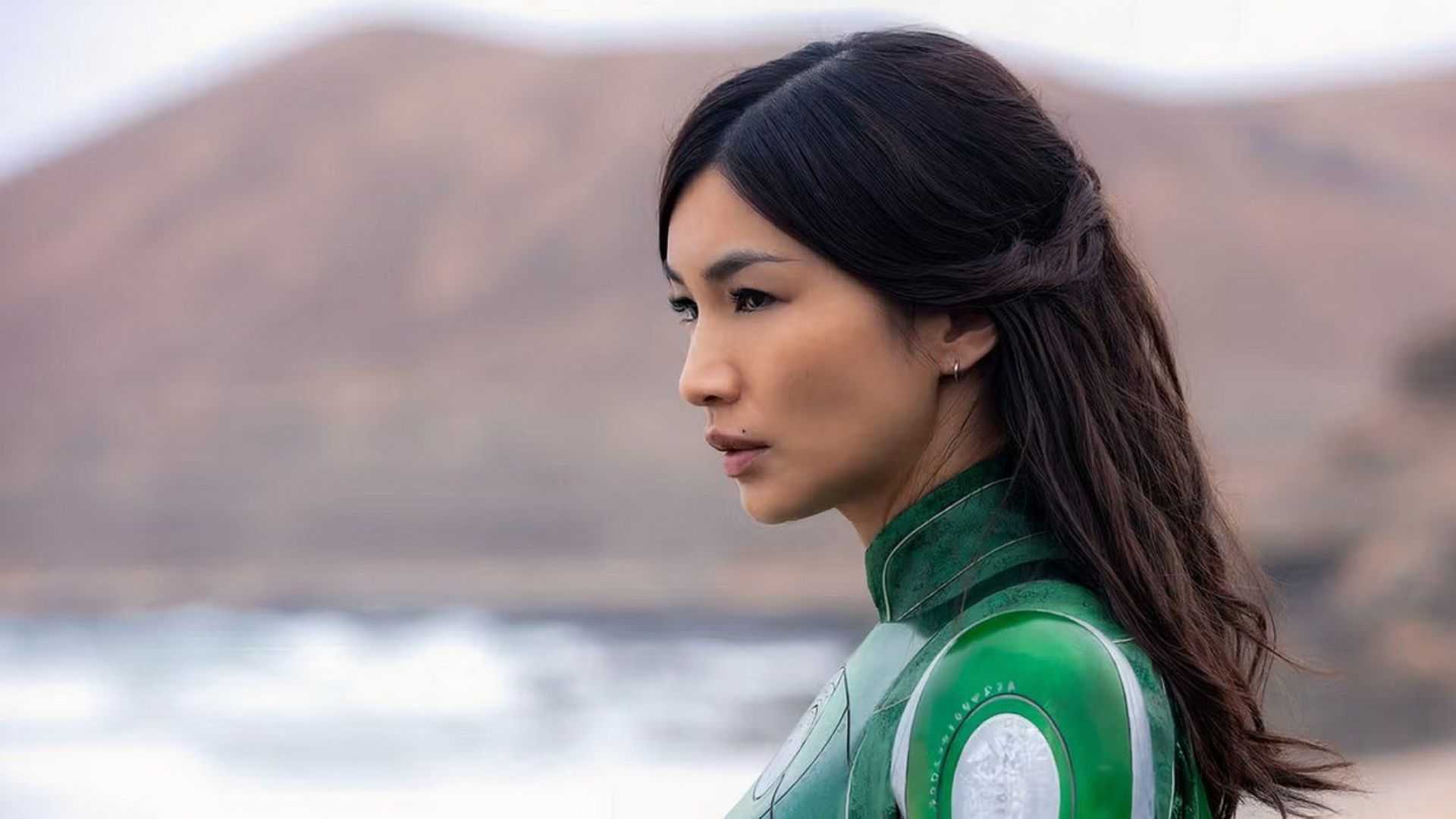 Gemma Chan wearing a green suit of armor, seen in profile as Sersi in Eternals